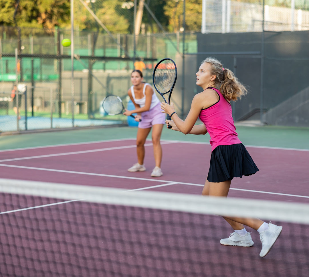 Tennis players practicing on outdoor tennis courts